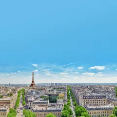 A view of Paris rooftops with the Eifel Tower on the horizon